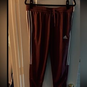 adidas Originals Burgundy Joggers with White Stripes.
